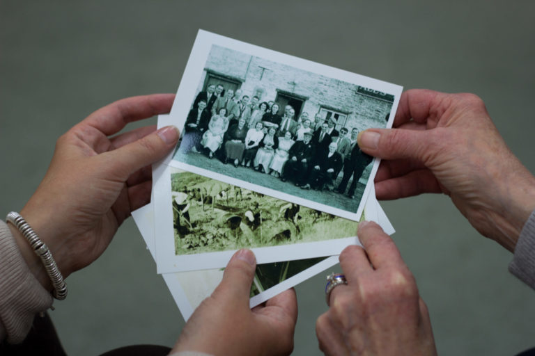 Hands holding old family photos