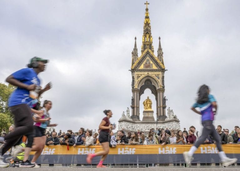 runners passing in front of a monument in one of London's Royal Parks in the London Royal Parks Half Marathon