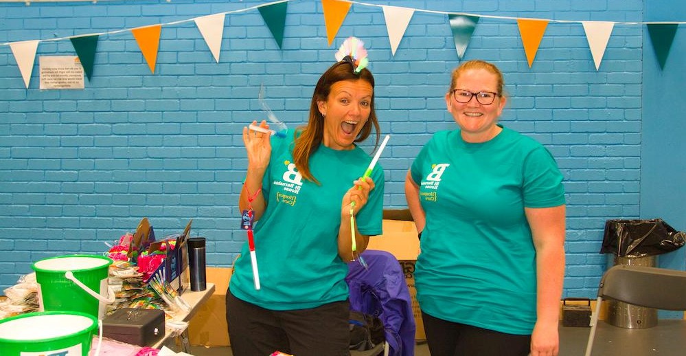 Two happy volunteers at a St Barnabas Event