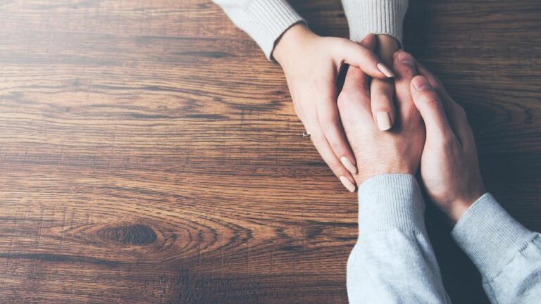 Image of two adults holding hands
