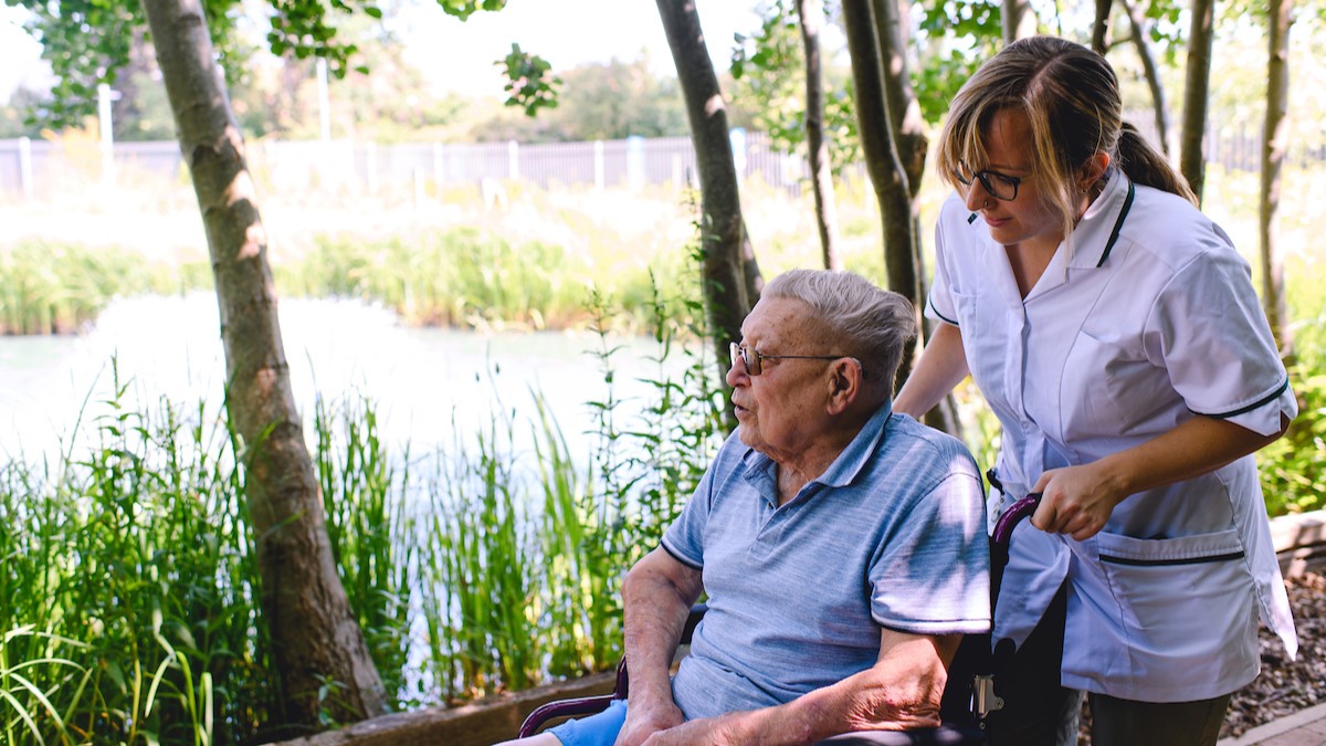 A patient and occupational therapist out in the hospice gardens.