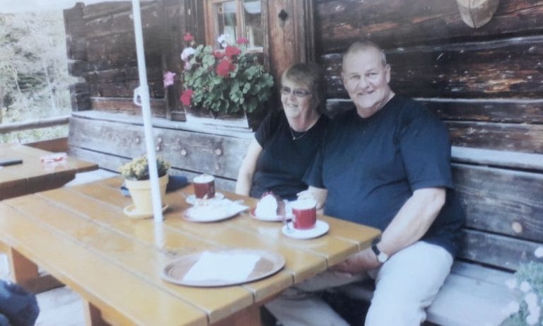 A couple sitting at a coffee table