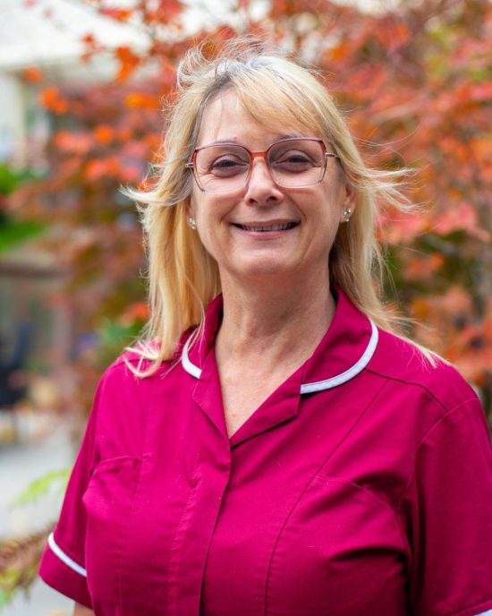 Katie stands in the gardens at St Barnabas House