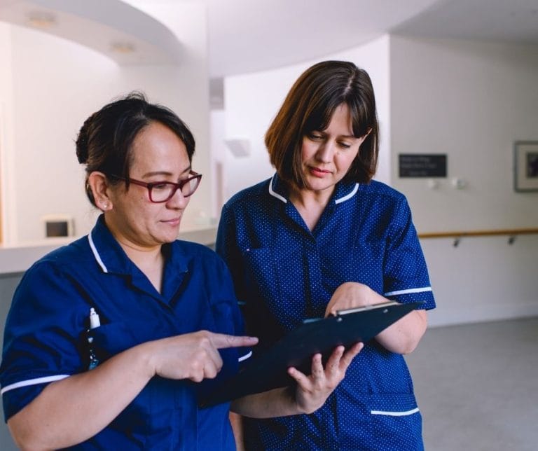 Nurses at St Barnabas House hospice consult patient notes