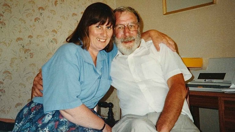 Liz and Tony sit with their arms around each other in an old family photograph.