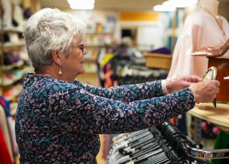 a retail volunteer in one of our charity shops, organising a display