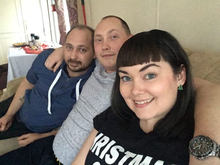 Dan, Carl and Marie sat together on the sofa, smiling at the camera