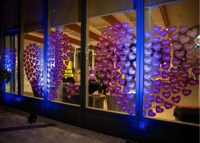 hear shaped decals on the hospice windows, lit up on a dark evening